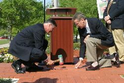 Bert Hartsfield and Dr. Bill Law lay the first brick in the TCC Circle of Remembrance.