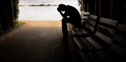 Man sitting on porch sad